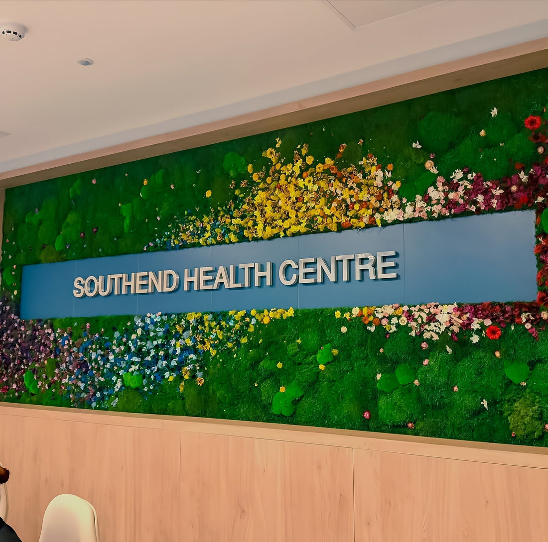 Southend Health Centre reception, Brushed metal 3D logo letters, sustainable wood paneling, Preserved moss wall installation with dried floral art, Preserved moss wall installation with dried floral art,
