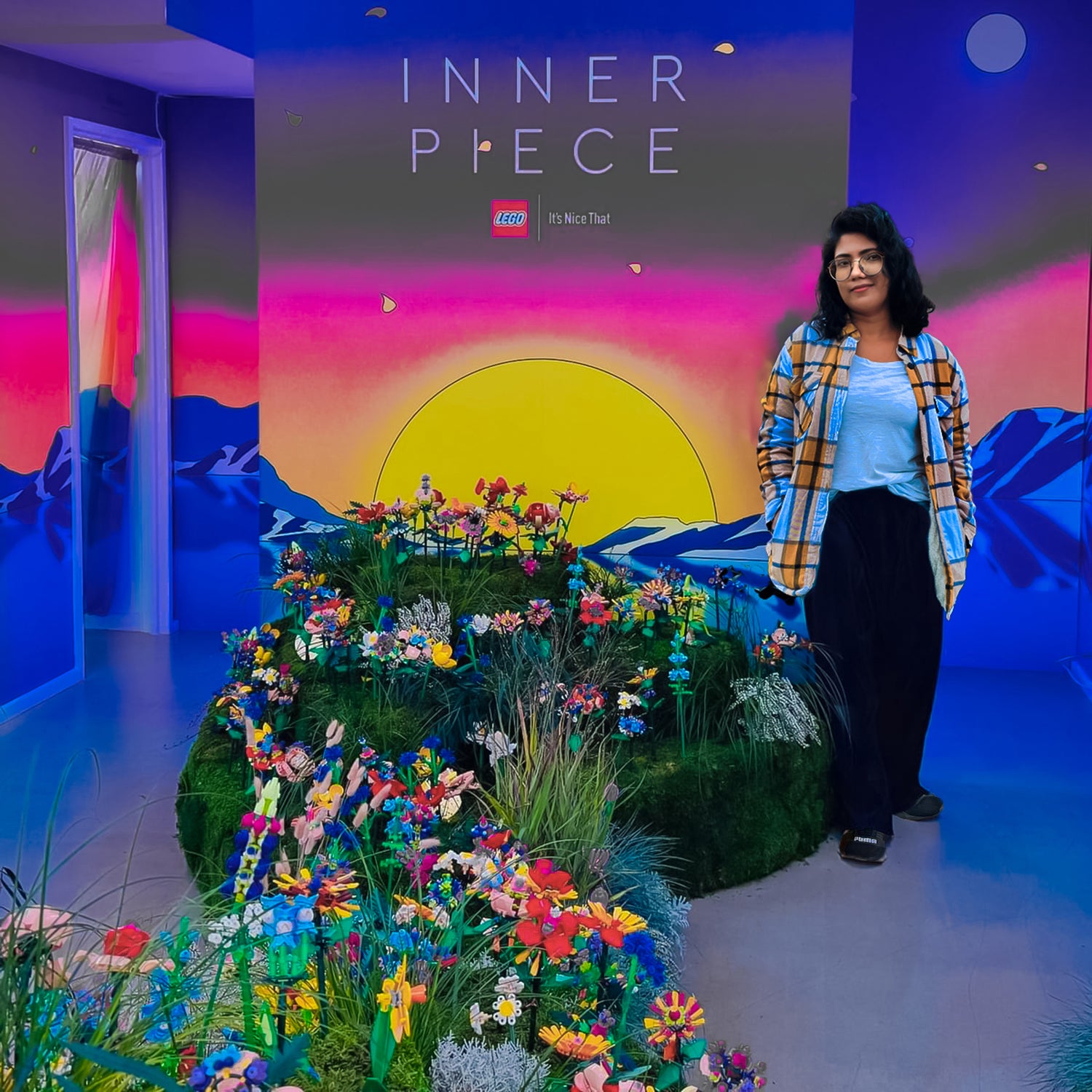 Person standing in front of a colorful display with 'INNER PIECE' branding.
